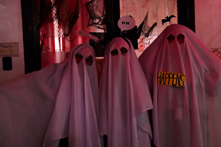 A group dressed as bedsheet ghosts