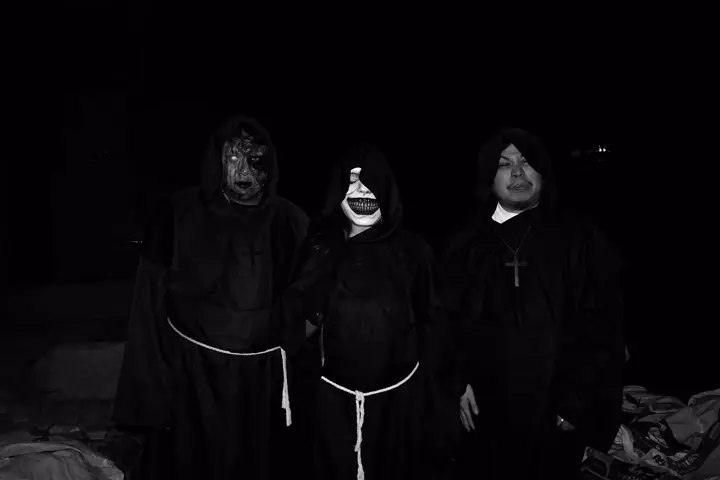Three teammates dressed as hooded nuns