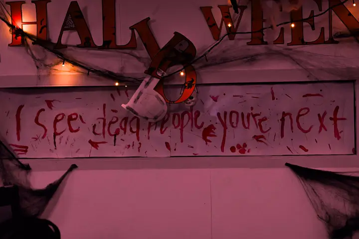 Bloody 'I see dead people, you're next' banner over the desks