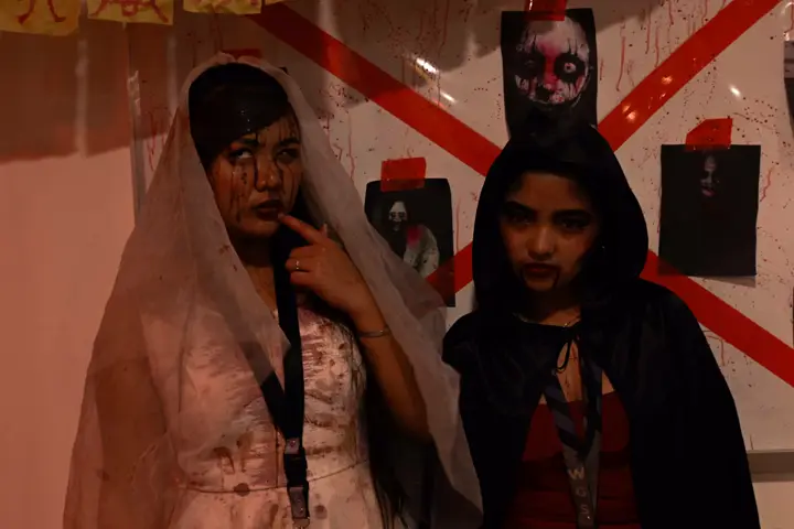 A ghost bride and a hooded figure posing together