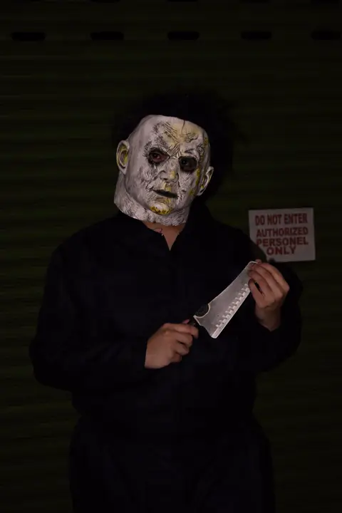 Teammate in a white slasher mask holding a prop knife